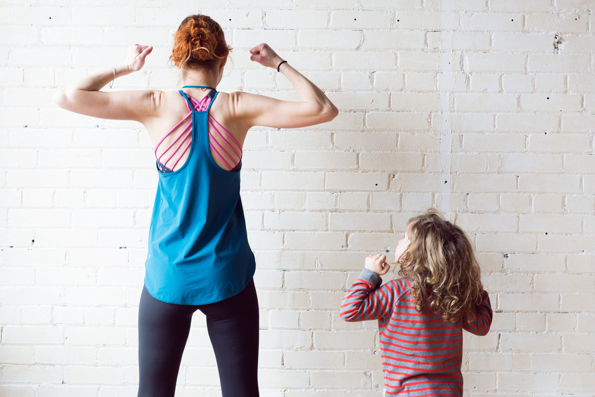 Woman with a little boy showing muscle